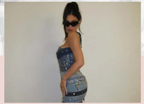 Kylie Jenner shows off her famous curves in a skintight denim dress just months after welcoming her son