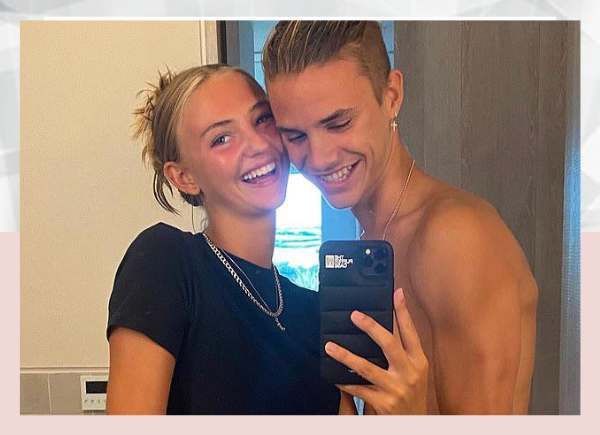 Romeo Beckham gets a kiss on the cheek from an unidentified woman.